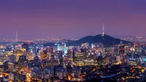 Seoul at night, seen from Namsan, with N Seoul Tower lit above the downtown skyline