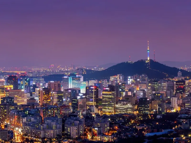 Seoul at night, seen from Namsan, with N Seoul Tower lit above the downtown skyline
