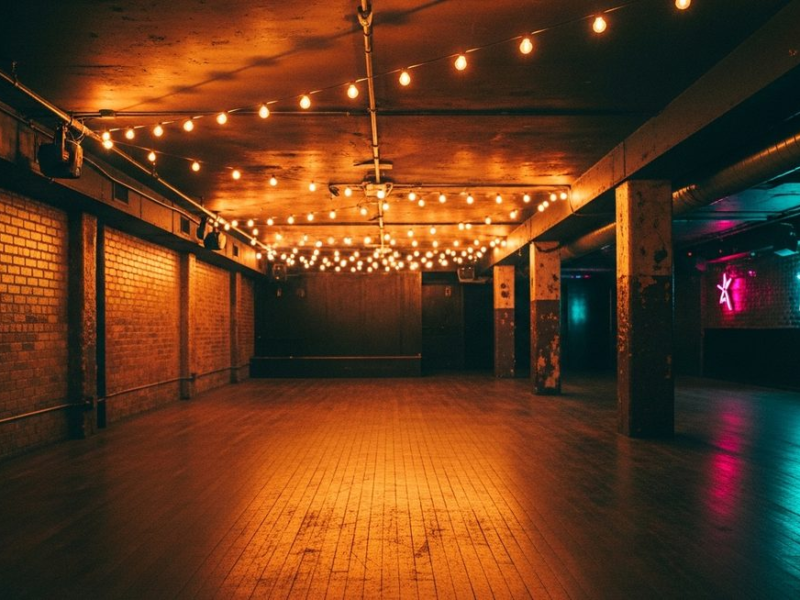 Vintage underground club with warm amber and honey-gold tones on exposed brick, worn floor, string lights, timeless atmosphere