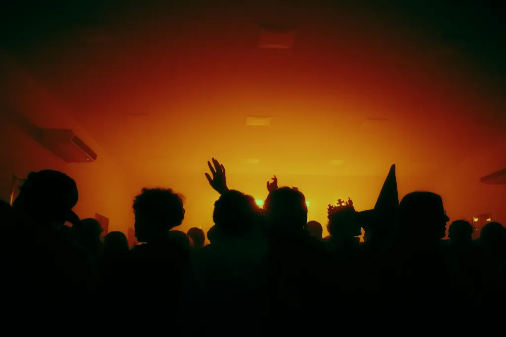 crowd hands up warm light