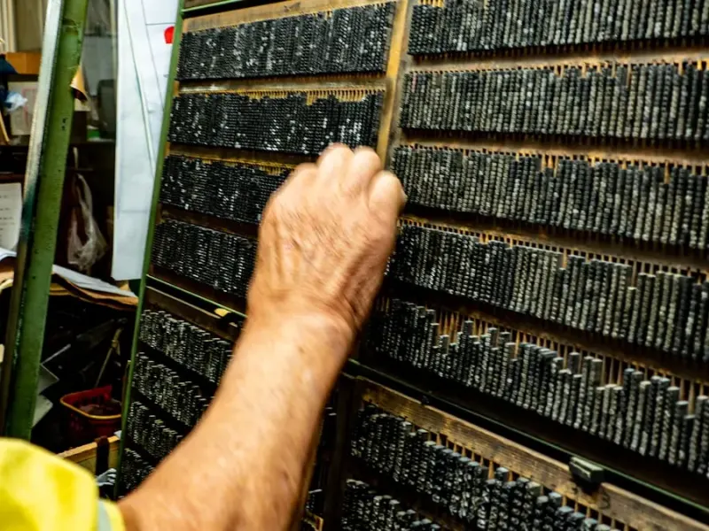 Hand selecting metal type from a case, the print alley craft