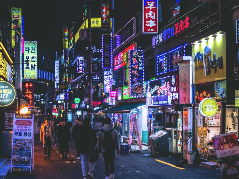 Crowded Seoul street under neon signs at night