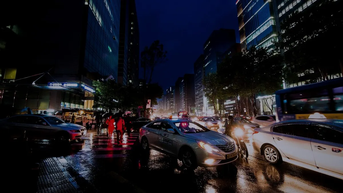 Traffic and wet streets in Gangnam on a rainy evening