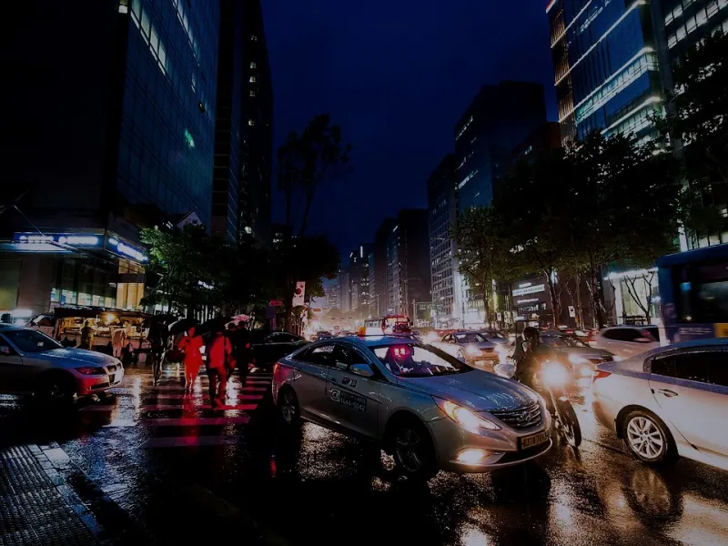 Traffic and wet streets in Gangnam on a rainy evening