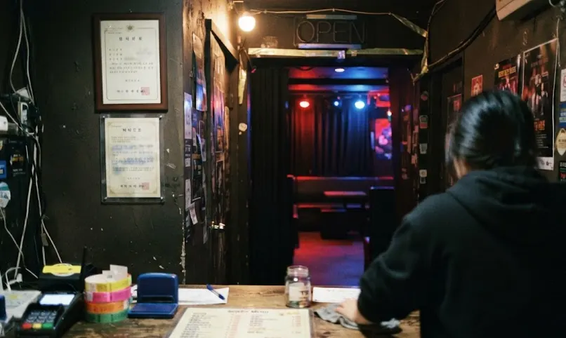 The entrance counter of a small Seoul bar club before opening, framed certificates on the wall