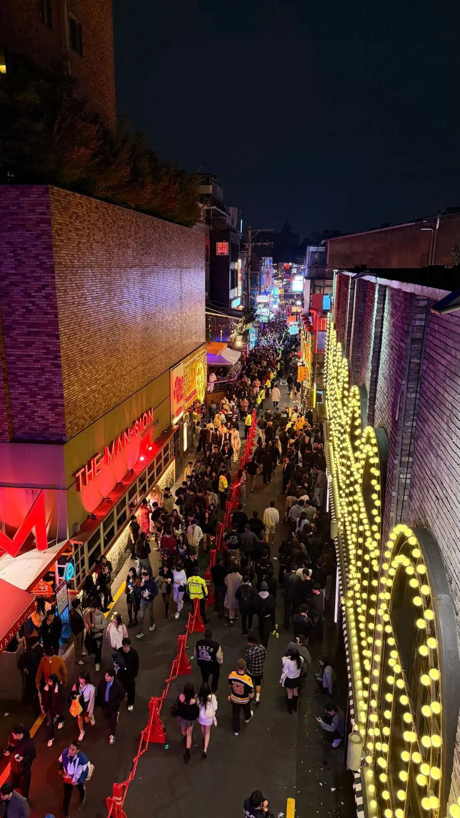 World Food Street last Halloween, people walking in lanes past police