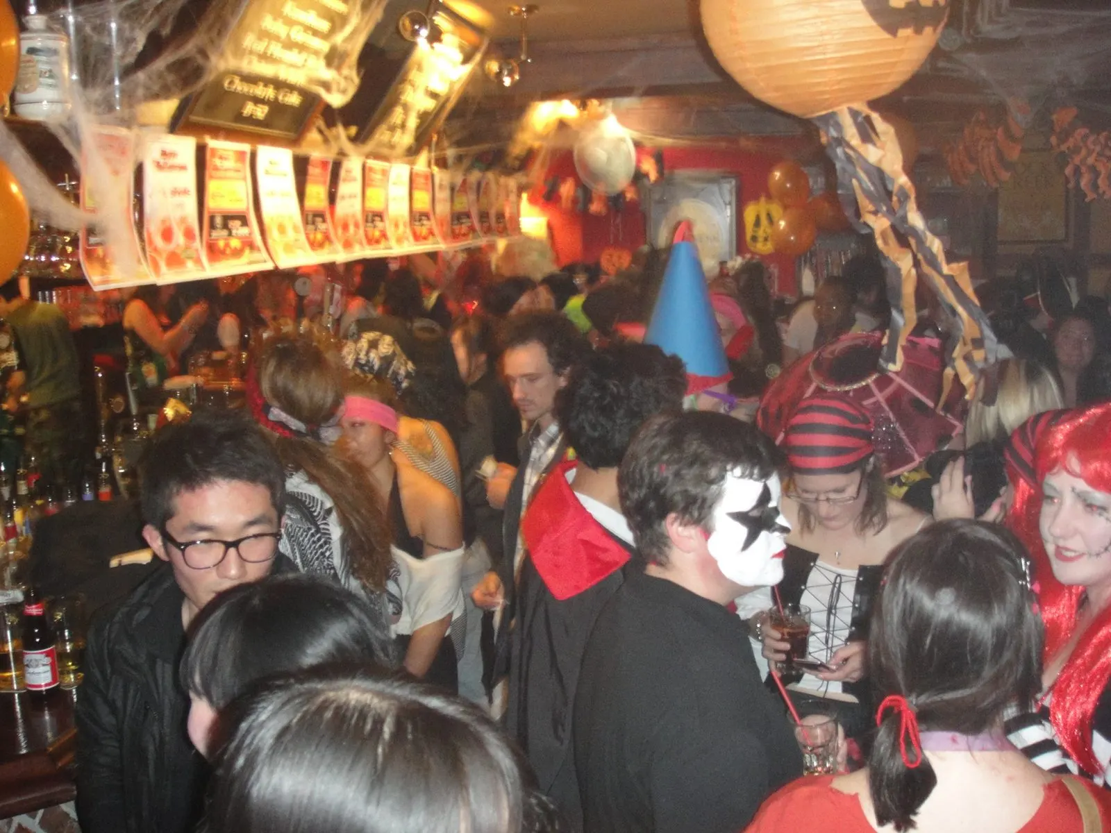A packed Itaewon pub decorated for Halloween, full of people in costumes