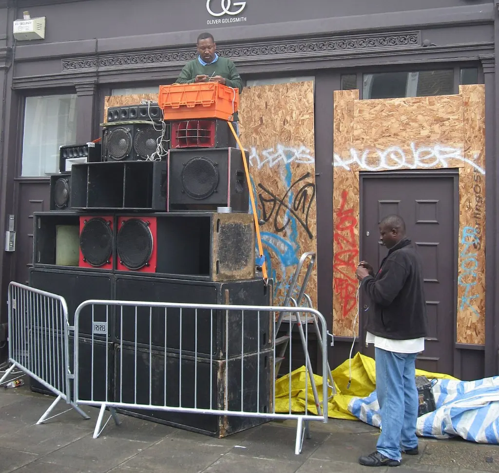 A sound system being stacked and set up outdoors