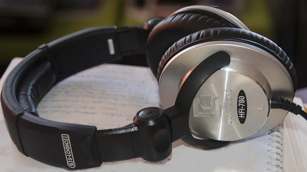 A pair of studio headphones resting on a notebook.